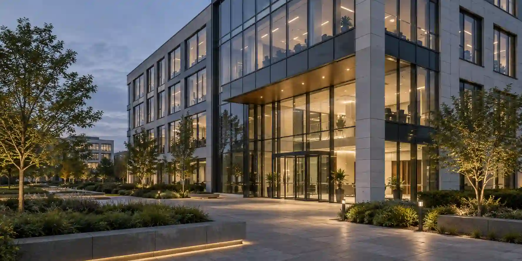 Illustrative modern commercial office building at dusk